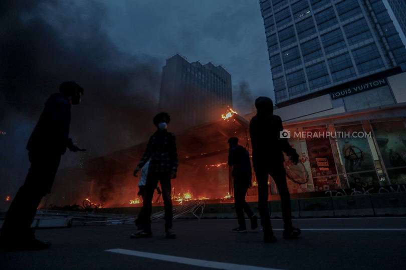 Sejumlah halte bus Transjakarta dan fasilitas umum lainnya dirusak massa aksi yang menolak pengesahan Undang-undang Cipta Kerja saat menyampaikan aspirasinya di jalan M.H Thamrin, Jakarta, Kamis, (8/10/2020). Kerusuhan terjadi setelah massa aksi tidak terima dibubarkan pihak Kepolisian karena bertindah anarkistis. Puluhan personil Brimob POLRI dengan kendaraan taktis dan water canon mendorong mundur massa untuk membubarkan diri. Merahputih.com / Rizki Fitrianto