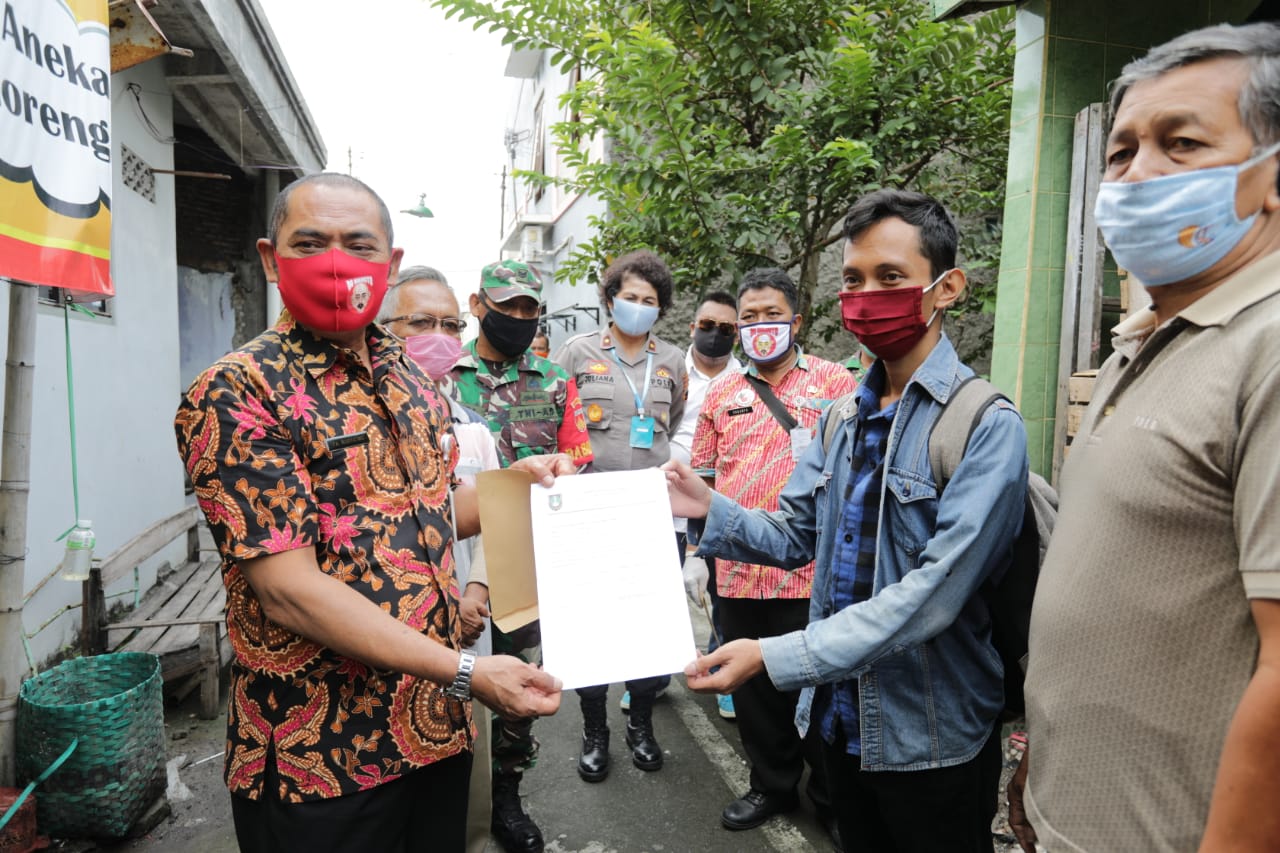 Wali Kota Solo, FX Hadi Rudyatmo (kiri) memberikan surat keterangan sehat bagi ODP COVID-19 yang selesai jalani karantina, Jumat (1/5). (MP/Ismail)