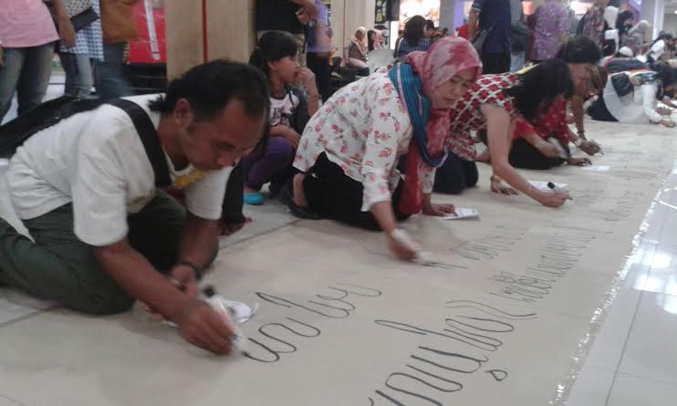 Sejumlah masyarakat sangat antusias saat menuliskan tulisan aksara Jawa. (MP/Win)