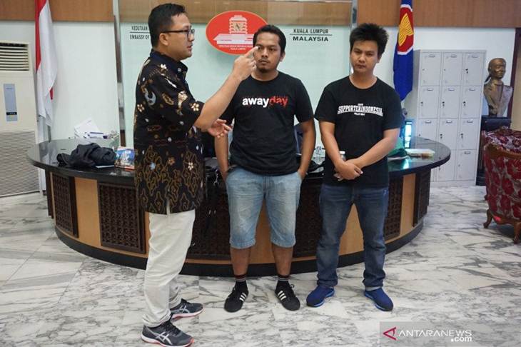 Koordinator Fungsi Sosial dan Budaya Agung Cahaya Sumirat (kiri) berbincang-bincang dengan dua orang suporter Indonesia yang telah dibebaskan Polisi Diraja Malaysia (PDRM) Rifki Chorudin (tengah) dan Iyan Prada Wibowo (kanan) di KBRI Kuala Lumpur, Minggu (24/11/2019). Foto ANTARA/Agus Setiawan (1)