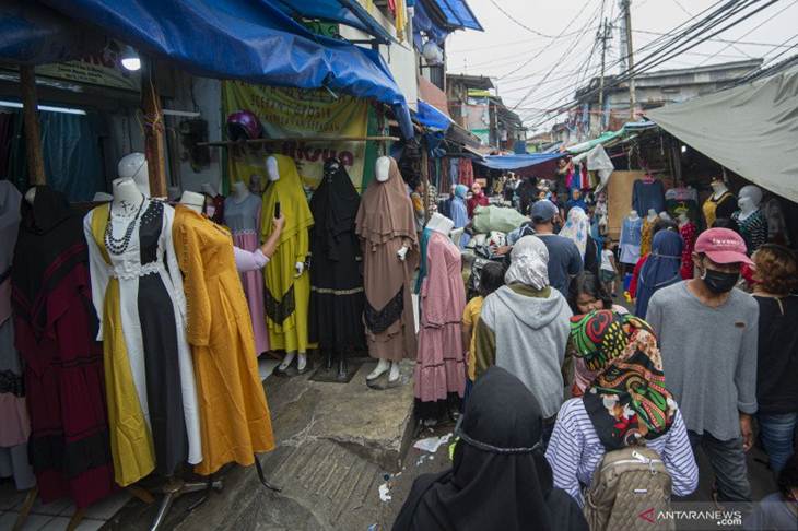 Warga berbelanja pakaian yang dijual pedagang kaki lima di Jalan Jati Baru II, Tanah Abang, Jakarta, Senin (18/5/2020). Meski kawasan niaga Pasar Tanah Abang telah tutup selama masa Pembatasan Sosial Berskala Besar (PSBB), namun sebagian oknum pedagang tetap menggelar lapaknya di sejumlah titik seperti di atas trotoar dan di gang perkampungan setempat. ANTARA FOTO/Aditya Pradana Putra/hp.