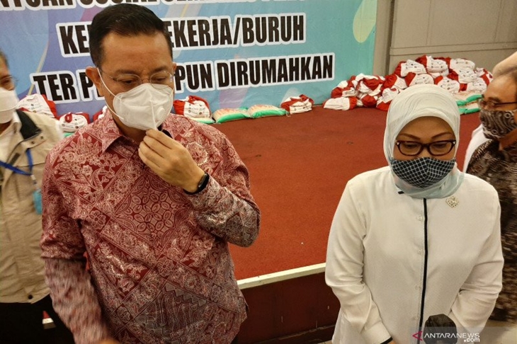 Menaker Ida Fauziyah (kanan) dan Mensos Juliari Batubara dalam upacara penyerahan bansos kepada pekerja terdampak pandemi di Kantor Kemnaker, Jakarta pada Rabu (17/6/2020) (ANTARA/Prisca Triferna)