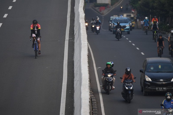 Sejumlah pesepeda memacu kecepatan saat berlangsungnya uji coba pemberlakuan lintasan road bike di jalan layang non tol (JLNT) Kampung Melayu-Tanah Abang, Jakarta, Minggu (23/5/2021). ANTARA FOTO/Akbar Nugroho Gumay/aww.