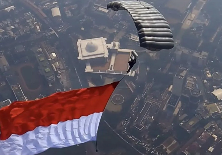 Spektakuler! 17 Penerjun Kopassus Kibarkan Merah Putih di Langit Monas