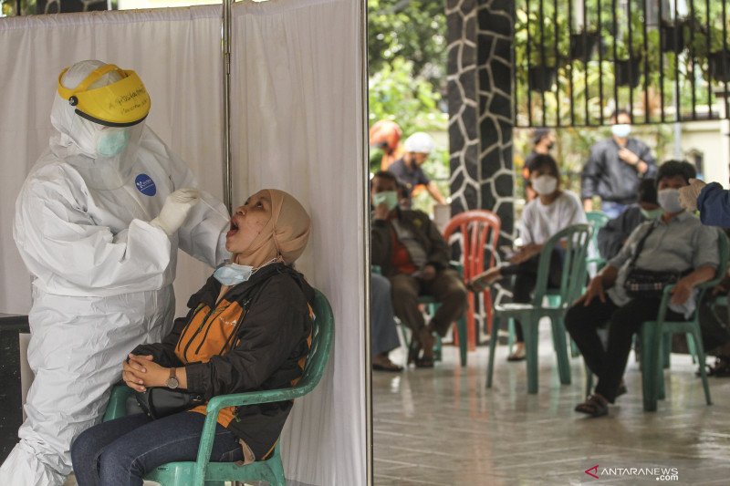 Petugas kesehatan mengambil sampel lendir seorang warga saat tes usap RT PCR COVID-19 massal di Kantor Kecamatan Pancoran Mas, Depok, Jawa Barat, Kamis (7/1/2021). UPTD Puskesmas Pancoran Mas melakukan tes usap PCR kepada warga yang memiliki riwayat kontak erat dengan pasien terkonfirmasi positif guna melacak penyebaran COVID-19. ANTARA FOTO/Asprilla Dwi Adha