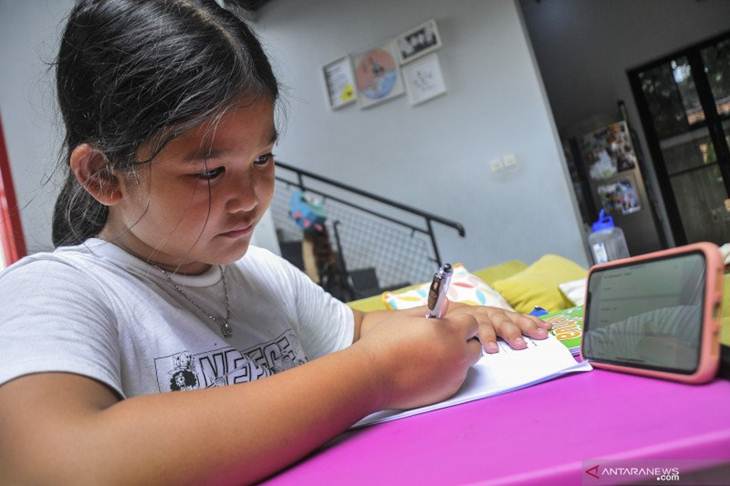 Siswi SD (Sekolah Dasar) belajar menggunakan sistem daring (online) di Jakarta Timur, Kamis (19/3/2020). Kementerian Pendidikan dan Kebudayaan terus mengembangkan sistem pembelajaran secara daring (dalam jaringan) untuk menekan tingkat penyebaran wabah COVID-19 yang kian masif di Indonesia. ANTARA FOTO/Fakhri Hermansyah/aww