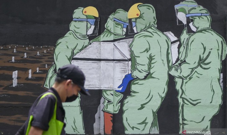 Warga melintas di depan mural tentang pandemi COVID-19 di Bukit Duri, Jakarta, Sabtu (9/1/2021). (ANTARA FOTO/GALIH PRADIPTA)