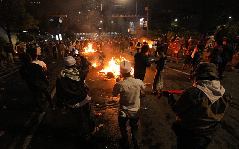 Sambil nyanyikan Indonesia Raya massa serang petugas polisi