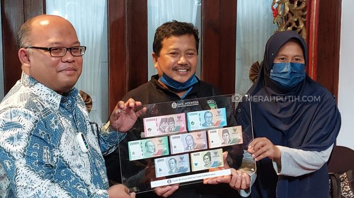 Kepala Perwakilan BI Solo Nugroho Joko Prastowo mengganti uang rusak milik warga yang dimakan rayap, Kamis (15/9). (Ismail/Jawa Tengah)