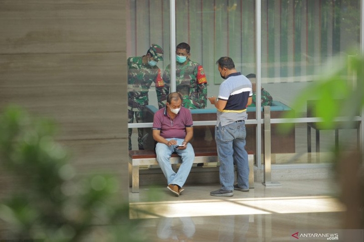 Sejumlah aparat keamanan berkoordinasi di Hotel Holiday Inn Jalan Gajah Mada, Jakarta, Minggu (25/4/2021). Satuan Tugas Penanganan COVID-19 menyiapkan Hotel Holiday Inn sebagai tempat karantina terpusat bagi 141 warga negara asing khususnya warna negara India yang negatif COVID-19 untuk dilakukan pemantauan selama 14 hari ke depan. ANTARA FOTO/Reno Esnir/wsj.
