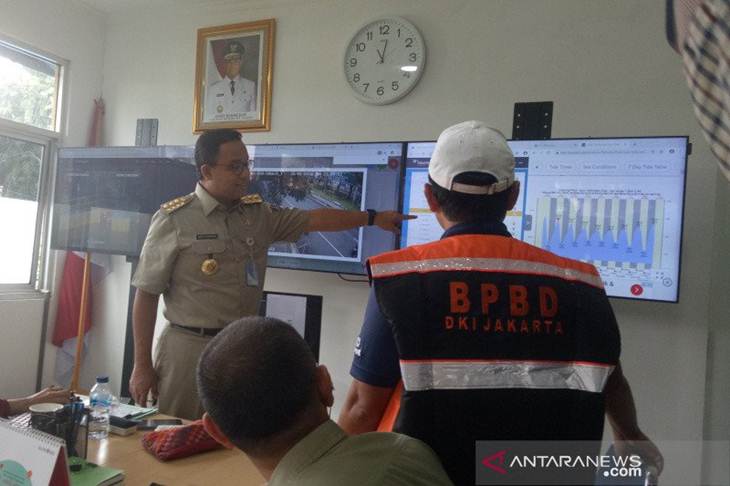 Gubernur DKI jakarta Anies Baswedan mengecek ketinggian air di berbagai pintu air lainnya secara live melalui monitor di Pos Pantau Pintu Air Manggarai, Selasa (25/2/2020) (ANTARA/ Livia Kristianti)