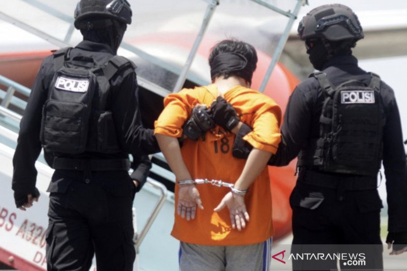Personel Densus 88 Antiteror menggiring terduga teroris ke Pesawat di Bandara Internasional Juanda, Surabaya, Jawa Timur, Kamis (18/3/2021). ANTARA/Umarul Faruq
