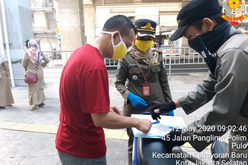 Petugas Satpol PP Kelurahan Pulo, Jakarta Selatan, memberikan teguran administratif kepada warga yang tidak menggunakan masker pada saat petugas melaksanakan pengamanan, pengawasan dan ketertiban di pasar darurat Blok A, Selasa (12/5/2020) (ANTARA/HO-Kominfotik Jakarta Selatan)