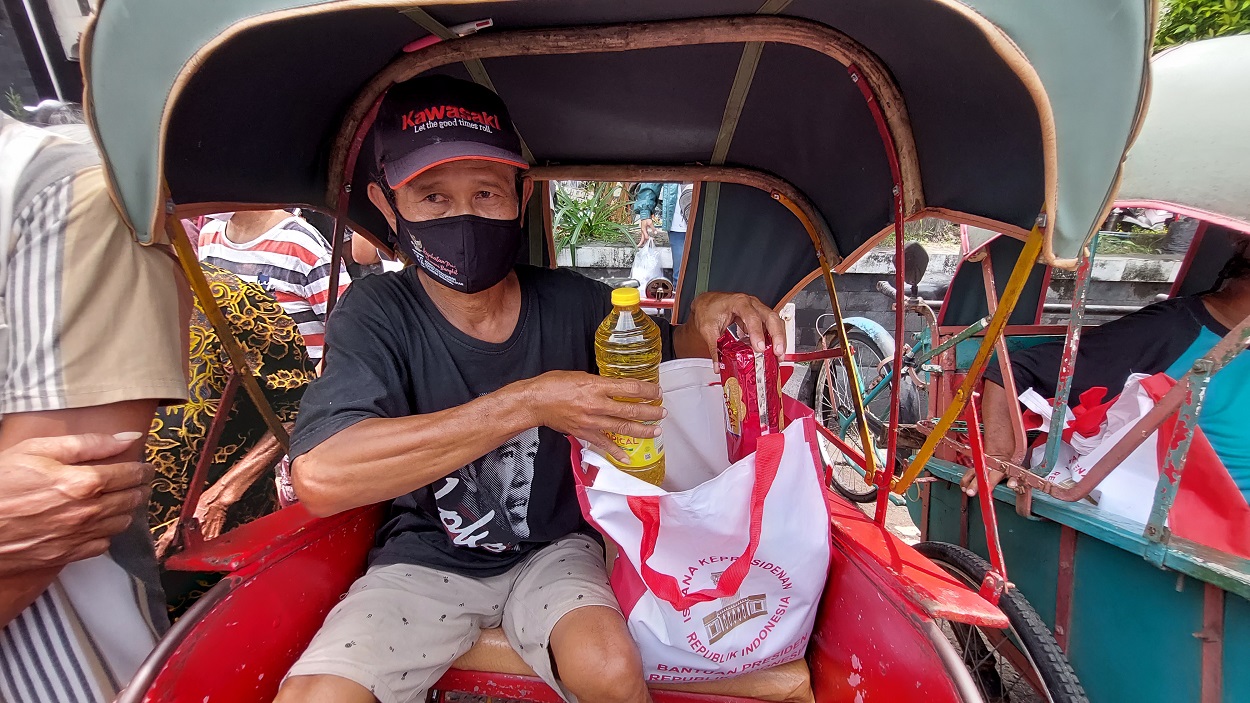 Warga mendapatkan paket sembako yang diberikan dari Presiden Jokowi di Pasar Kleco Solo, Jawa Tengah, Senin (13/9). (MP/Ismail)
