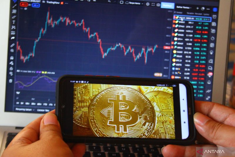 Pelaku bisnis Kripto, Nanda Rizal memantau grafik perkembangan nilai aset kripto, Bitcoin di Malang, Jawa Timur, Sabtu (12/3/2022). ANTARA FOTO/Ari Bowo Sucipto/rwa. (ANTARA FOTO/ARI BOWO SUCIPTO)