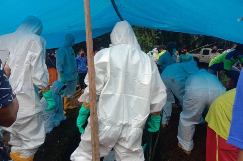Relawan PMI Pasaman Barat saat memakamkan pasien COVID-19 yang meninggal dunia, Selasa