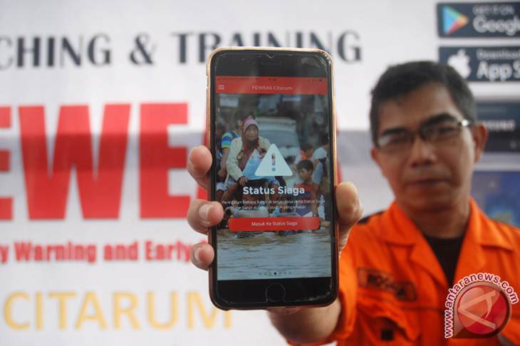 Petugas BPBD memperlihatkan aplikasi sistem peringatan bencana dini untuk mengurangi resiko banjir Sungai Citarum atau Flood Early Warning and Early Action System (FEWEAS), saat diluncurkan, di Bandung, Jawa Barat, Senin (11/12/2017). International Federation of Red Cross and Red Crescent Socities (IFRC), PMI dan Zurich Insurance Indonesia (ZII) meluncurkan FEWEAS guna membantu mewujudkan ketangguhan masyarakat terhadap bencana banjir, mendukung kesiapsiagaan PMI, mengurangi risiko kerugian akibat banjir, mitigasi risiko bencana banjir bagi masyarakat yang bermukim di wilayah Daerah Aliran Sungai (DAS) Citarum. (ANTARA FOTO/Fahrul Jayadiputra)
