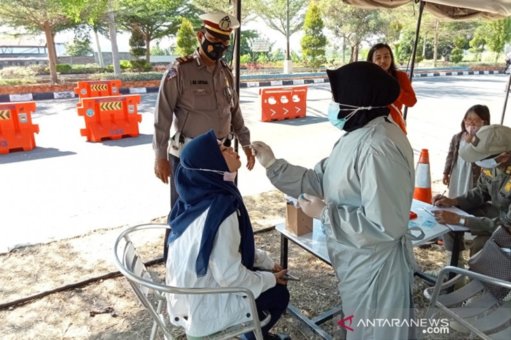 Petugas medis melakukan tes cepat antigen kepada salah seorang warga di pos penyekatan PPKM Kota Mataram di Jalur Bypass BIL, Bundaran Tugu Mataram Metro, NTB, Selasa (20/7/2021). ANTARA/HO-Polda NTB