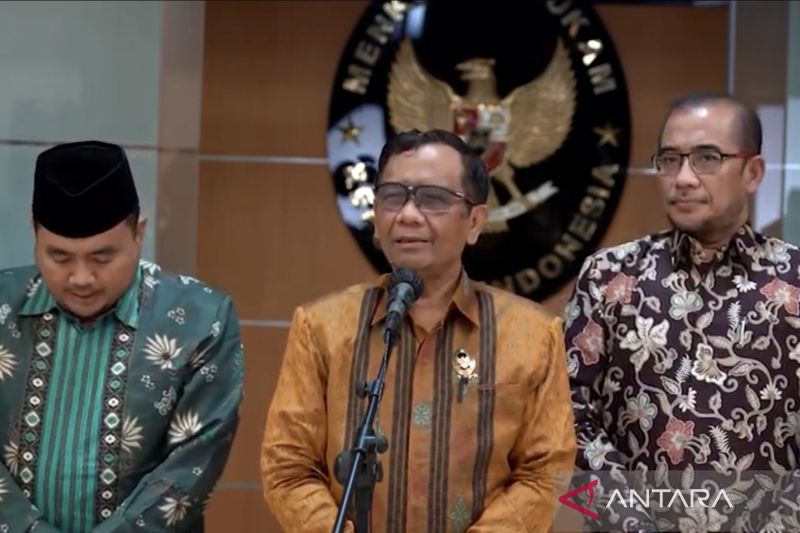 Menkopolhukam Mahfud MD (tengah) dan Ketua KPU Hasyim Asy’ari (kanan) memberi keterangan kepada media usai keduanya bertemu di Kantor Kemenko Polhukam RI, Jakarta, Rabu (11/5/2022) sebagaimana disiarkan kanal YouTube Kemenko Polhukam. ANTARA/Genta Tenri Mawangi