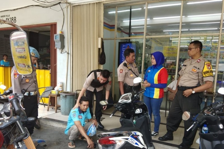 Anggota Polsek Kebon Jeruk menciduk salah satu terduga pelaku pungutan liar parkir di salah satu minimarket di Jakarta Barat, Rabu (6/11/2019). (ANTARA/DEVI NINDY)