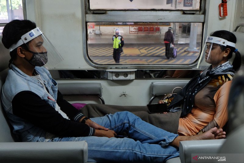 Penumpang memakai masker dan pelindung wajah (Face Shield)Â di Kereta Api (KA) Ranggajati relasi Cirebon-Jember saat transit di Stasiun Balapan, Solo, Jawa Tengah. ANTARA FOTO/Maulana Surya/aww.